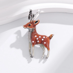 Detailed view of the deer brooch featuring brown enamel body and silver-tone metal antlers