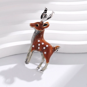 Brown enamel Christmas deer brooch with white spots on silver minimalist tiered stand