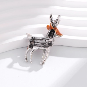 Back view of a vintage silver reindeer brooch with brown enamel and secure pin clasp detail