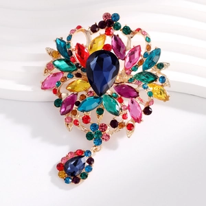 Detail of vintage colorful crystal brooch with gold metal and water drop pendant