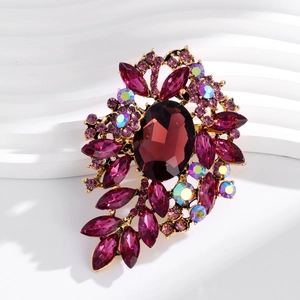 Detailed macro view of a vintage gold brooch with deep purple gemstones and AB crystals