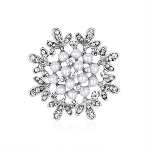 Detailed top view of a snowflake brooch with pearls and sparkling rhinestones