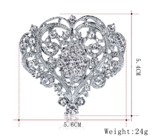 Detail view of heart brooch with dimensions 5.4cm by 5.6cm and shiny rhinestones