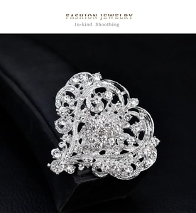 Detailed macro view of heart shaped silver brooch with sparkling white rhinestones