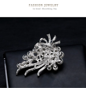 Macro detail of the silver bouquet brooch back with fine metal texture and pin clasp