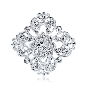 Macro shot of silver vintage-style brooch with rhinestones and floral openwork