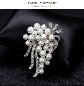 Detailed view of silver bouquet brooch with white pearls and rhinestones on black silk