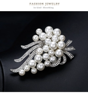 Detailed shot of a silver cluster brooch featuring white pearls and shimmering zircons