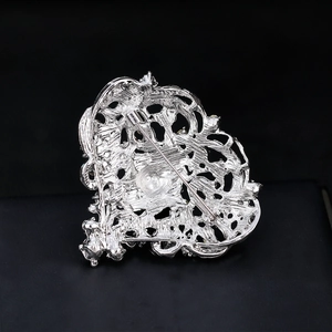 Silver openwork heart brooch with white rhinestones and a secure pin back for weddings