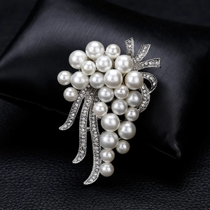 Elegant 18k white pearl bouquet brooch with sparkling crystal accents on black velvet