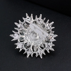 Elegant silver alloy pearl brooch with a sunburst snowflake design and back safety pin clasp