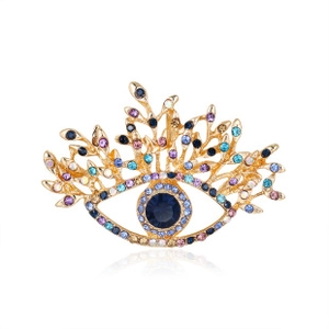 Detailed close-up of gold-plated evil eye brooch with colorful crystal rhinestones