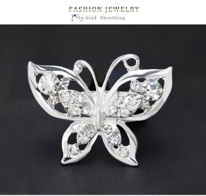 Macro shot of silver crystal butterfly brooch with hollow-out design and rhinestones