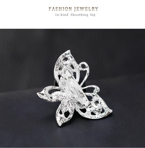 Detail view of the silver butterfly brooch back showing pin clasp and hollowed-out metal design