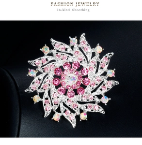 Vue détaillée d'une broche fleur spirale en cristal avec strass roses sur cuir noir