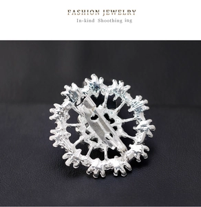 Macro shot of silver plated snowflake brooch back with secure pin on black leather