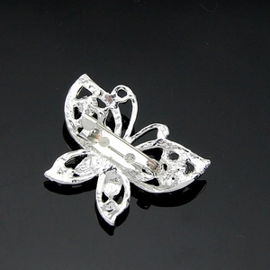 Silver butterfly brooch pin for women with detailed cutout design on black background