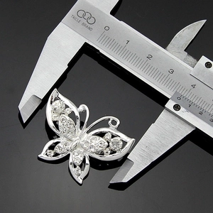Silver plated butterfly crystal brooch measuring 4.2cm width on a vernier caliper