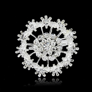Elegant silver-plated snowflake brooch with sparkling rhinestones on a black background