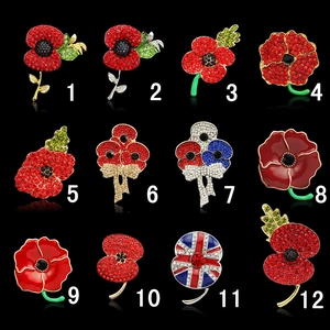 Detailed grid of twelve sparkling crystal red poppy brooches with diverse enamel designs