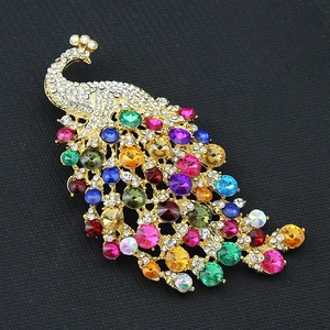 Oversized colorful crystal peacock brooch with gold finish and vibrant rhinestones