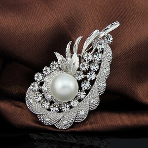 Elegant silver leaf brooch with large white pearl and sparkling rhinestones on silk