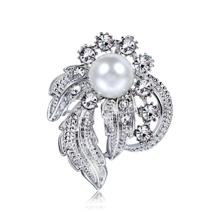 Elegant silver-plated floral brooch with large white pearl and sparkling zircons on white backdrop