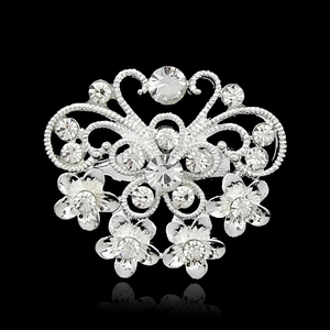 Silver alloy butterfly and floral brooch with clear crystals on a black background