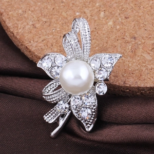 Elegant silver flower brooch with large white pearl and sparkling crystals on satin