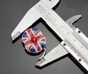 Detailed view of British flag poppy brooch measuring 3.5cm with a digital caliper