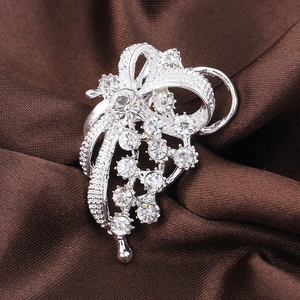 Silver-plated crystal flower brooch with rhinestone bow and dangling ribbons design