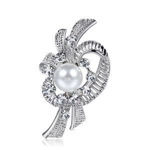 Elegant silver brooch with a white pearl center and sparkling rhinestones on white base