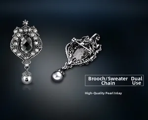 Detailed view of vintage alloy brooch with black faceted gemstone and gray pearl drop