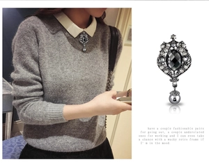 Detail view of retro silver brooch with black gemstone and crystal rhinstones