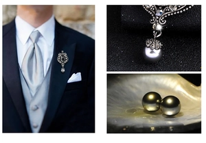 Detailed view of a vintage silver shield brooch with grey gemstone and pearl pendant for men