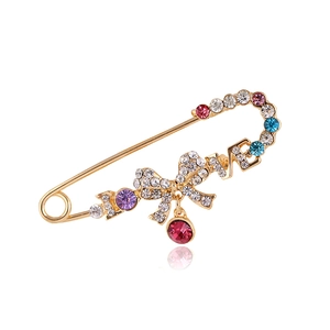 Fashionable gold brooch pin with colorful rhinestones, LOVE letters and a bow design