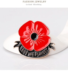 Detailed macro view of Poppy brooch with Lest We Forget engraving and red enamel finish
