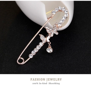 Detailed macro view of a rose gold butterfly brooch with shimmering white crystals