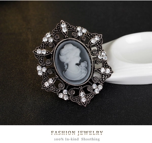 Macro shot of vintage Victorian lady cameo brooch with sparkling crystal rhinestones