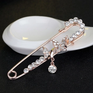 Luxurious rose gold butterfly brooch with pavé rhinestones and a crystal drop pendant
