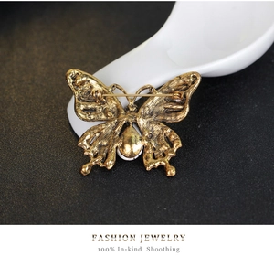 Macro detail of butterfly brooch back with pin clasp and textured metal surface