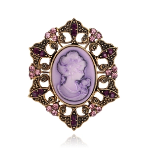 Vintage gold-plated cameo brooch with purple female silhouette and sparkling rhinestones