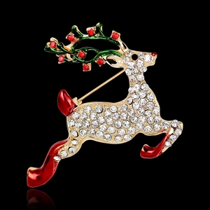 Broche de renne de Noël exquise avec strass blancs et bois en émail vert sur fond noir