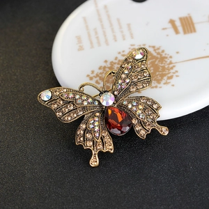 Vintage gold butterfly brooch with rhinestones and a large red pear-shaped gemstone