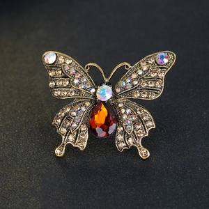 Vintage gold butterfly brooch with champagne crystals and orange teardrop gemstone