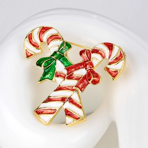 Festive Christmas candy cane brooch with red and white enamel stripes on gold base