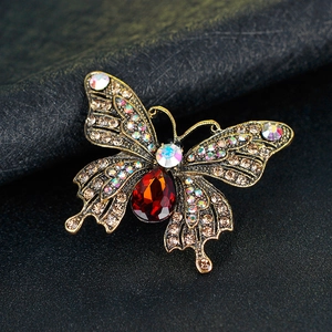 Vintage gold butterfly brooch with multicolored rhinestones and a large red pear-shaped stone