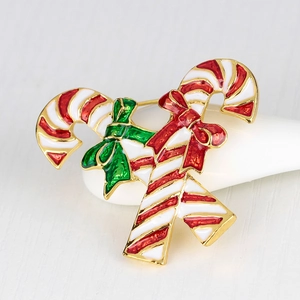 Christmas candy cane brooch with red white stripes and green bow in gold plating