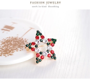 Detailed macro view of a Christmas star brooch with red, green and white crystal rhinestones