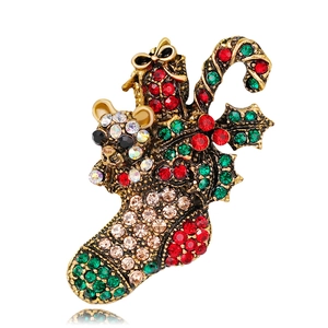 Close-up of festive Christmas stocking brooch with rhinestones and vintage gold finish
